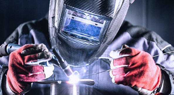 A welder works on project work as part of the defence industry