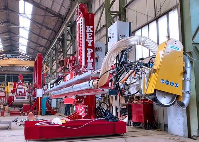 A column and boom internal seam grinding system